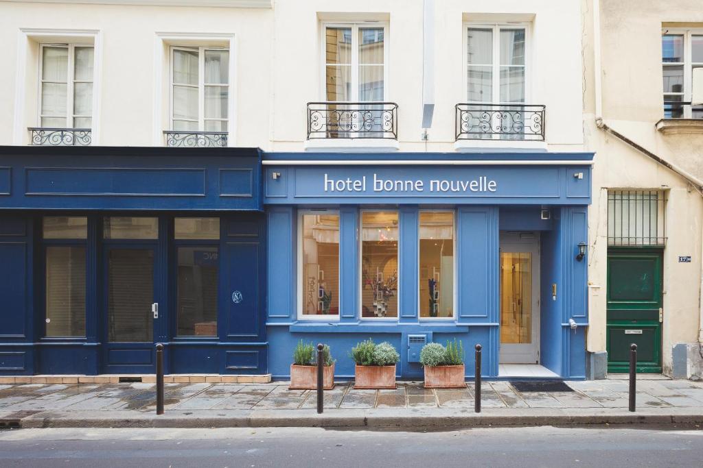 a blue and white building with a blue door at Hôtel Bonne Nouvelle in Paris