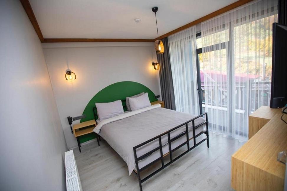 A bed or beds in a room at İspendam Tess Otel