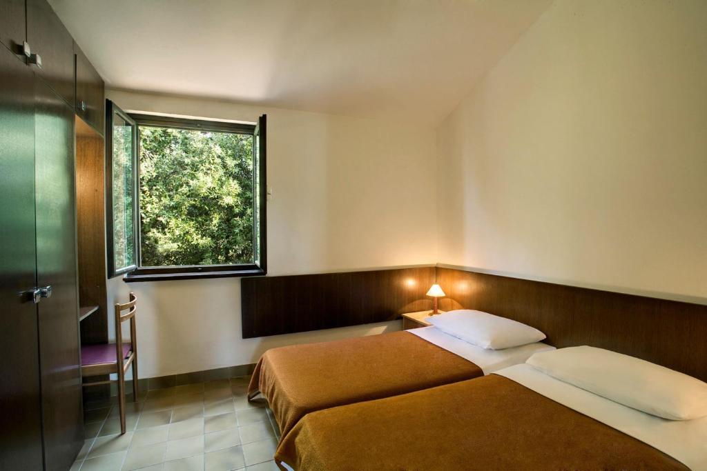 Postel nebo postele na pokoji v ubytování Lanterna Resort