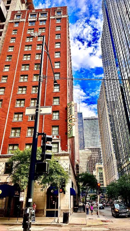 a tall red building on a city street with a traffic light at Hotel Saint Clair - Magnificent Mile in Chicago