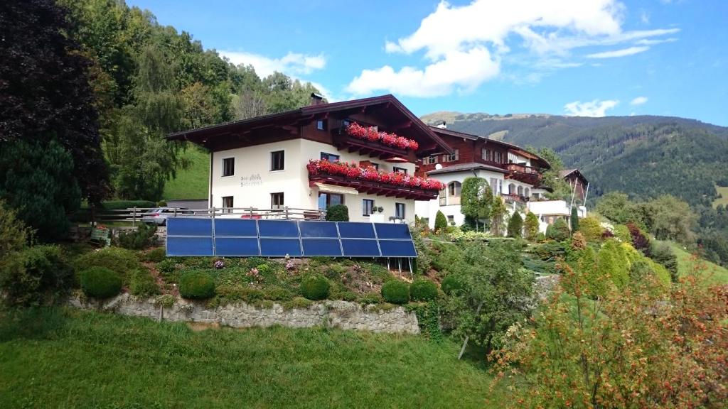 a house on a hill with a solar array on it at Haus Salzachblick in Piesendorf