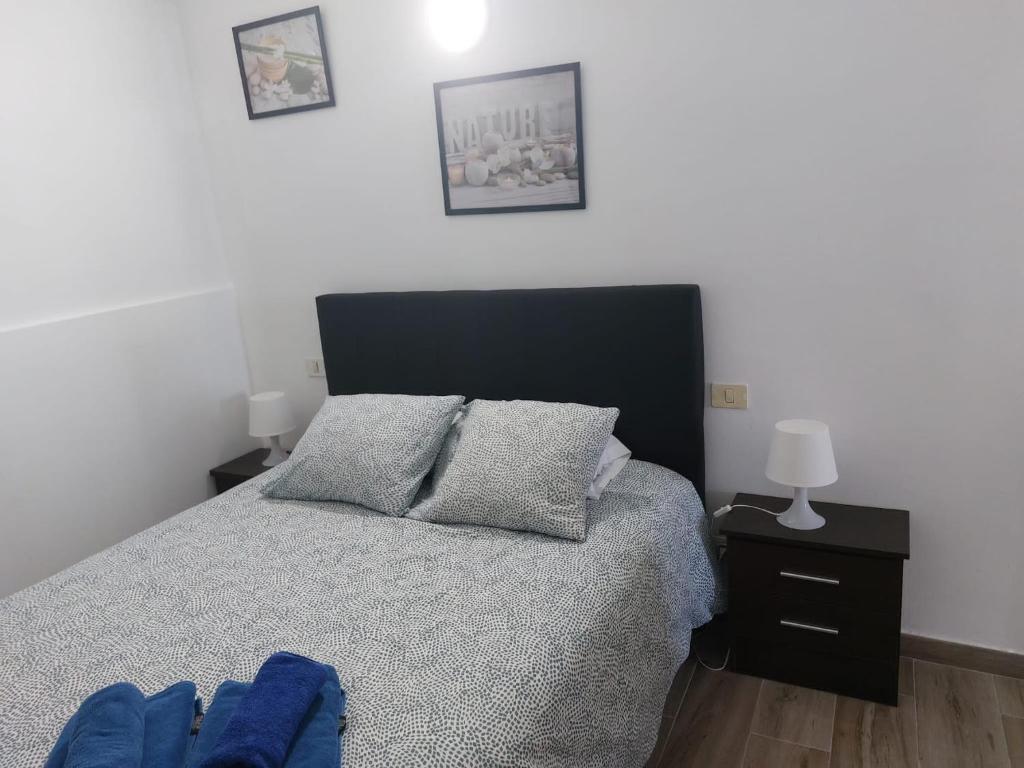 a bedroom with a bed with a black head board at Vista Puerto Ground Floor No Balcon in Arguineguín