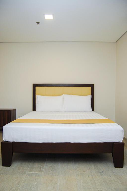 Postel nebo postele na pokoji v ubytování Kaia Isabelle Hotel Puerto Princesa