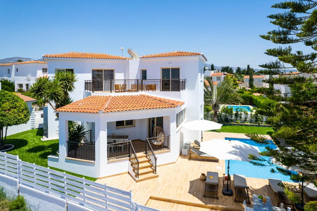 a villa with a view of the swimming pool at Harmonia Luxury Villa by Nomads in Peyia