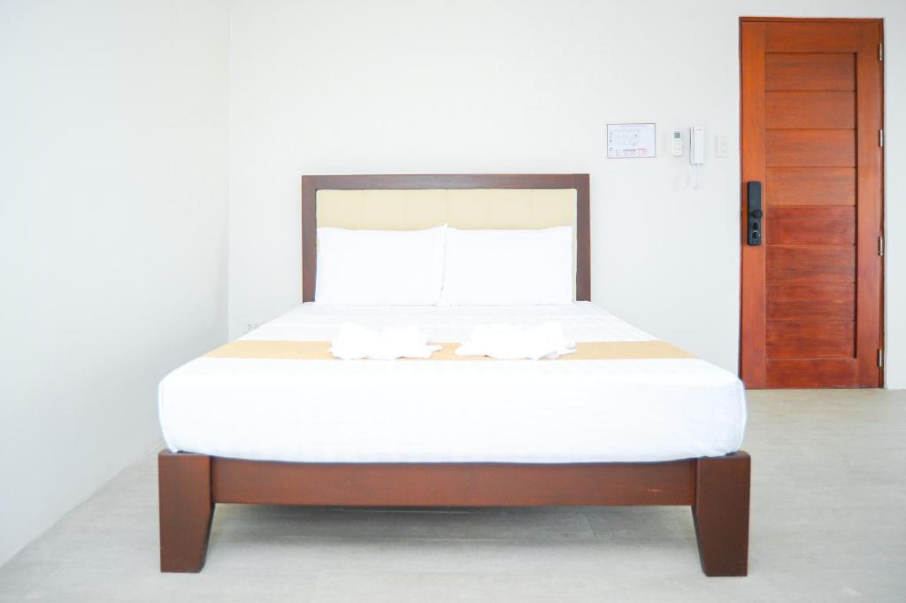 Postel nebo postele na pokoji v ubytování Kaia Isabelle Hotel Puerto Princesa