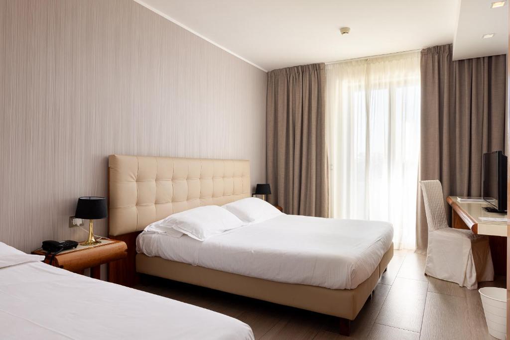 Postel nebo postele na pokoji v ubytování D'Aragona Lifestyle Hotel