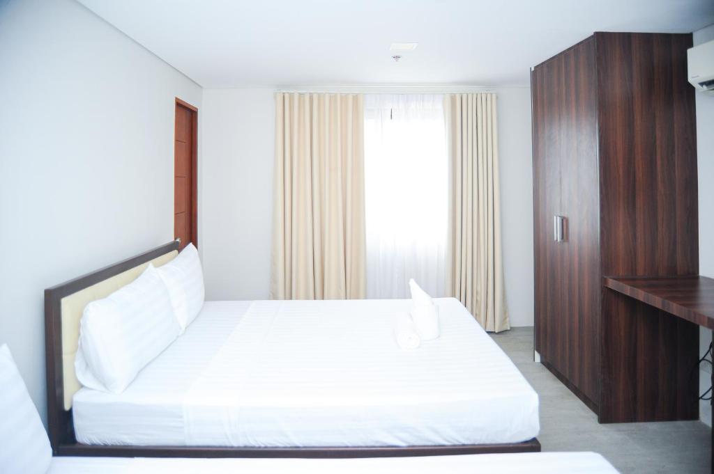 Postel nebo postele na pokoji v ubytování Kaia Isabelle Hotel Puerto Princesa