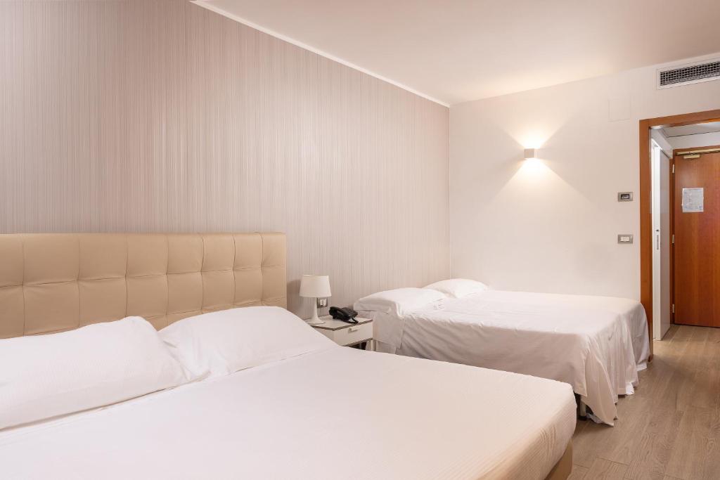 Postel nebo postele na pokoji v ubytování D'Aragona Lifestyle Hotel