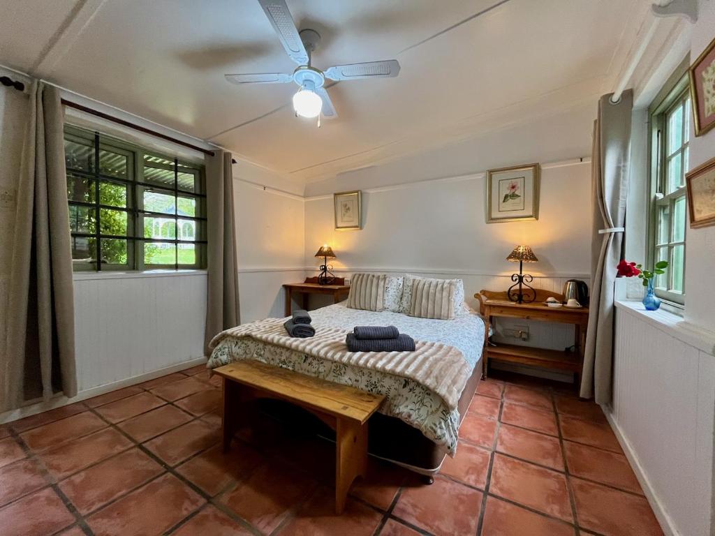 a bedroom with a bed and a ceiling fan at Tradouw Guesthouse in Barrydale