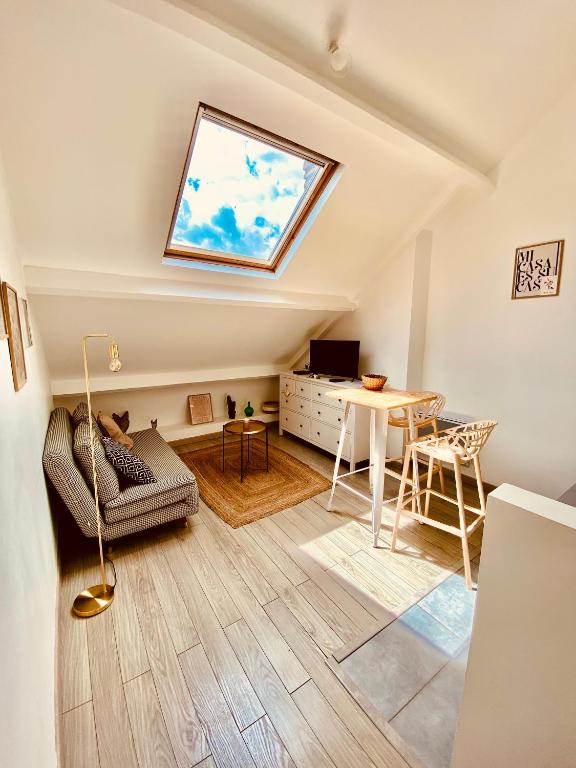 a living room with a skylight and a table at MiCASA, Studio avec Clim hyper centre in Tours