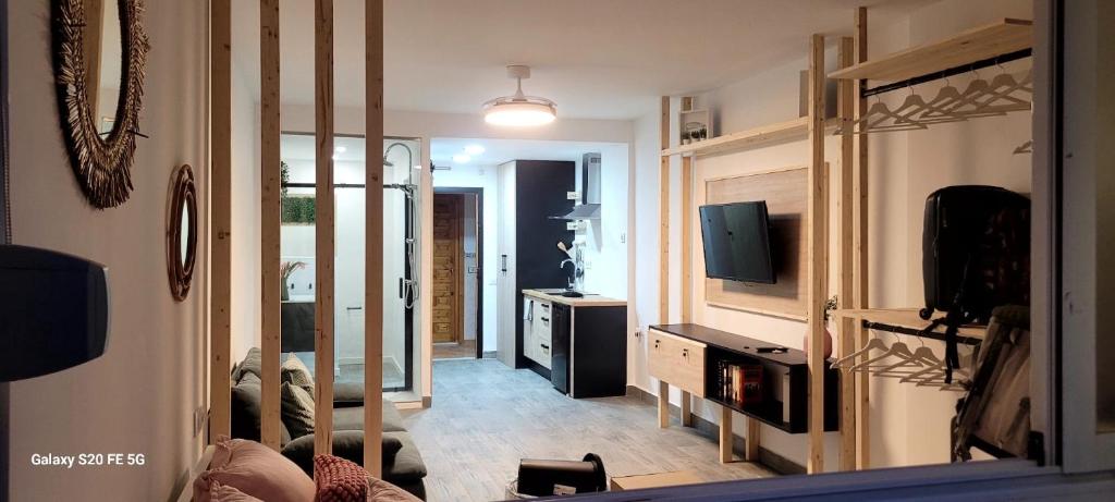 Una sala de estar con televisión y un espejo. en Escapada a Vera, en Vera