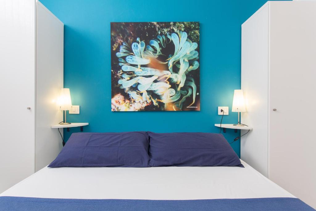 A bed or beds in a room at Mondello Suites FLH - Gorgonia