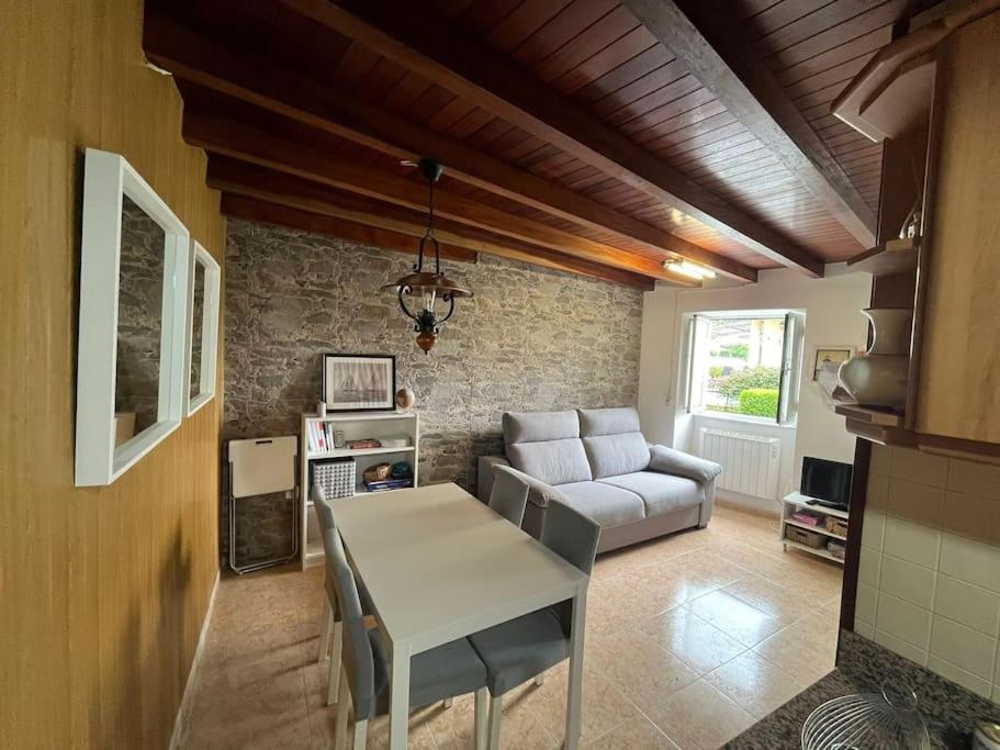 a living room with a couch and a table at La casa del valle in Viveiro