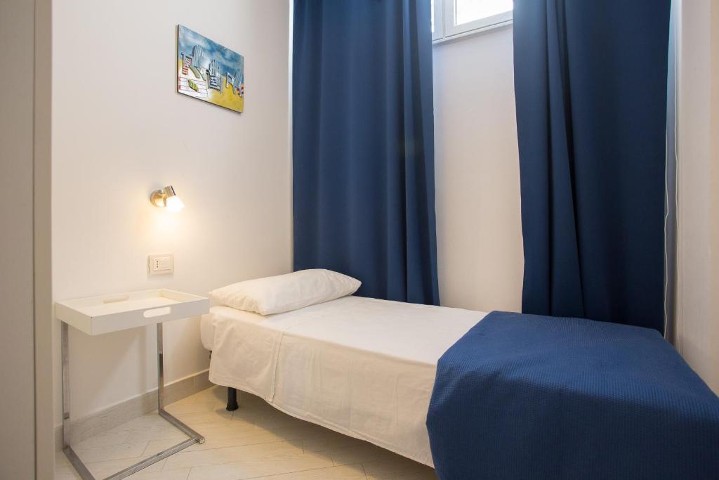 A bed or beds in a room at Mondello Suites FLH - Gorgonia