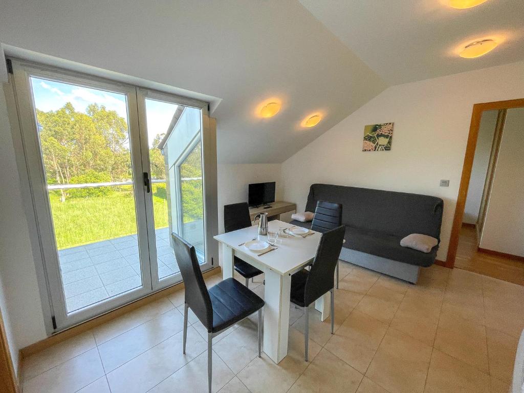 a living room with a table and a couch at Apartamentos Illa de Arousa 3000 in Isla de Arosa