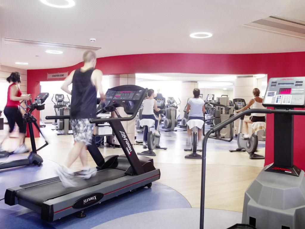 a group of people exercising on treadmills in a gym at Mondorf Parc Hotel & Spa in Mondorf-les-Bains