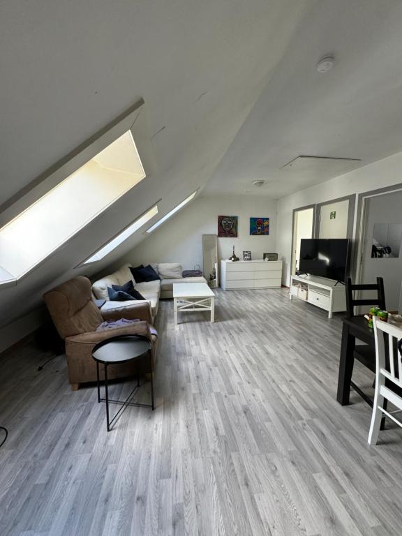 a large living room with a couch and a tv at Spacious and central apartment I 250m from Bryggen in Bergen