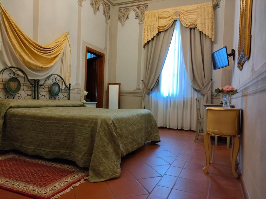 Postel nebo postele na pokoji v ubytování Hotel Villa Cheli