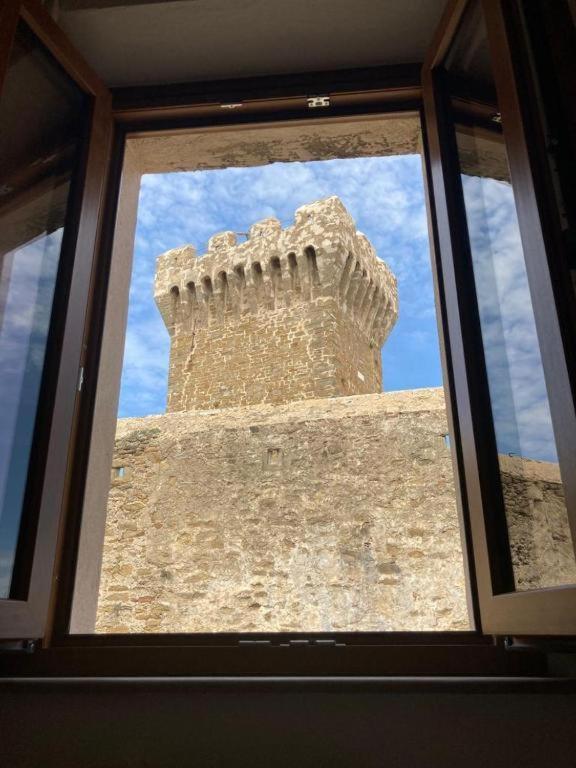 a window of a building with a tower at Populonia corso apartment in Populonia