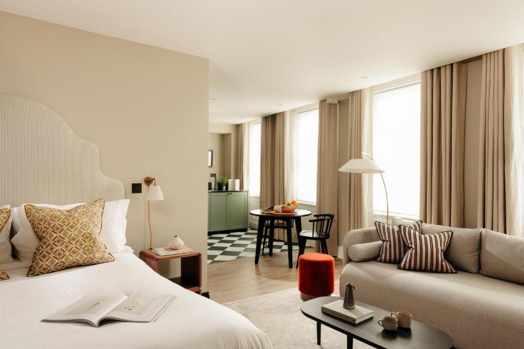 a hotel room with a bed and a couch at Native Kings Wardrobe, St Pauls in London