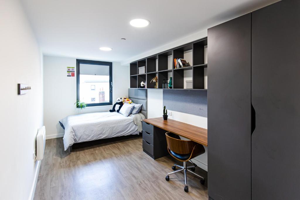 a bedroom with a bed and a desk at New Era Living - Private Rooms next to Bramall Lane in Sheffield
