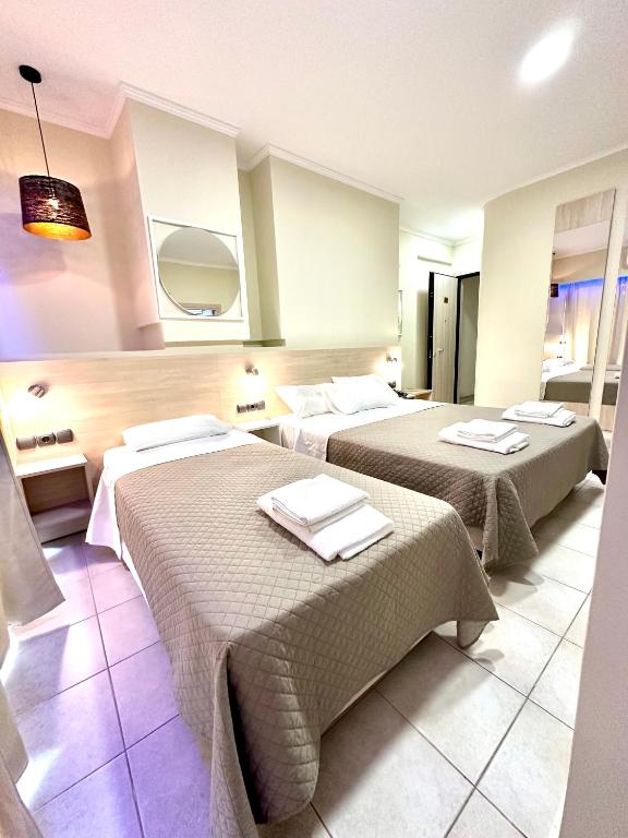 Postel nebo postele na pokoji v ubytování Hotel Akti