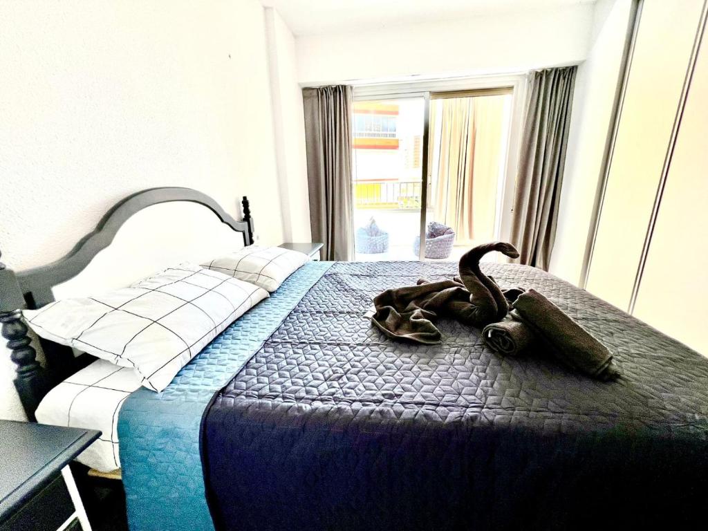 a bedroom with a large bed with a large window at Lovely apartment Esperanto in Benidorm