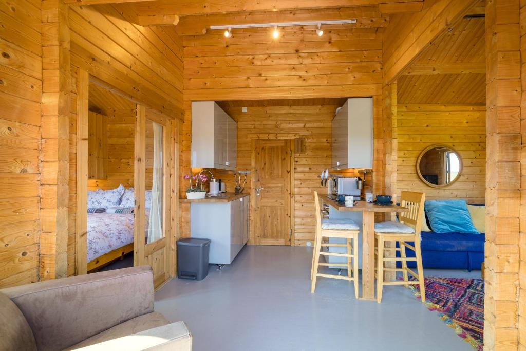 a kitchen and living room in a log cabin at Little Park Farm Queen Anne Farmhouse & Apartments in Stratfield Mortimer