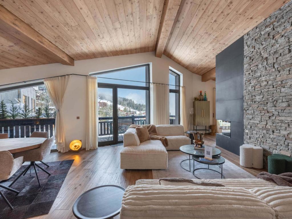 un salon avec un canapé et une table dans l'établissement Magnifique Duplex Neuf à Courchevel 1850 avec Accès Direct aux Pistes, SPA et Piscine - FR-1-564-106, à Courchevel