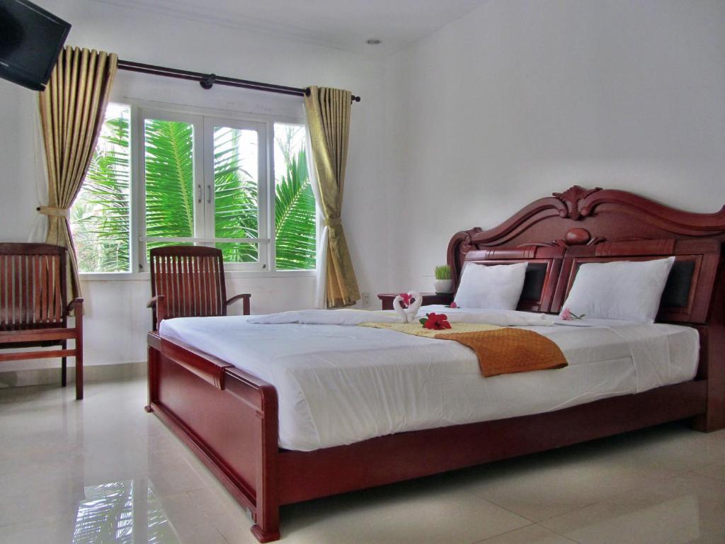 Giường trong phòng chung tại Hung Phuc Mui Ne Hotel