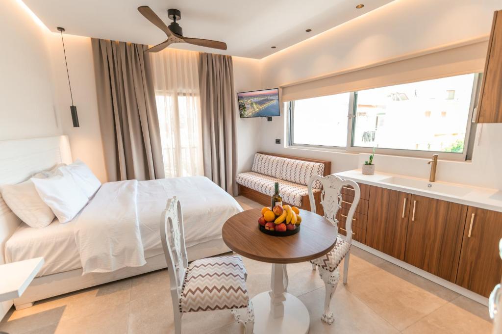 a bedroom with a bed and a table with a bowl of fruit at Granny's House in Kos Town