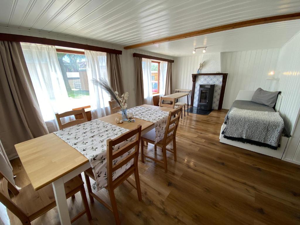 a dining room with a table and chairs and a bed at Cozy 2-Bedroom Bungalow in Interlaken