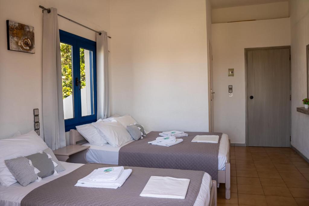 Postel nebo postele na pokoji v ubytování Giannis Rooms