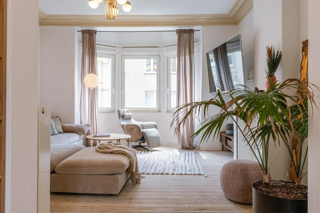 a living room with a couch and a table at Huswell - Relaxing Holiday Home with Private Sauna in Ostend