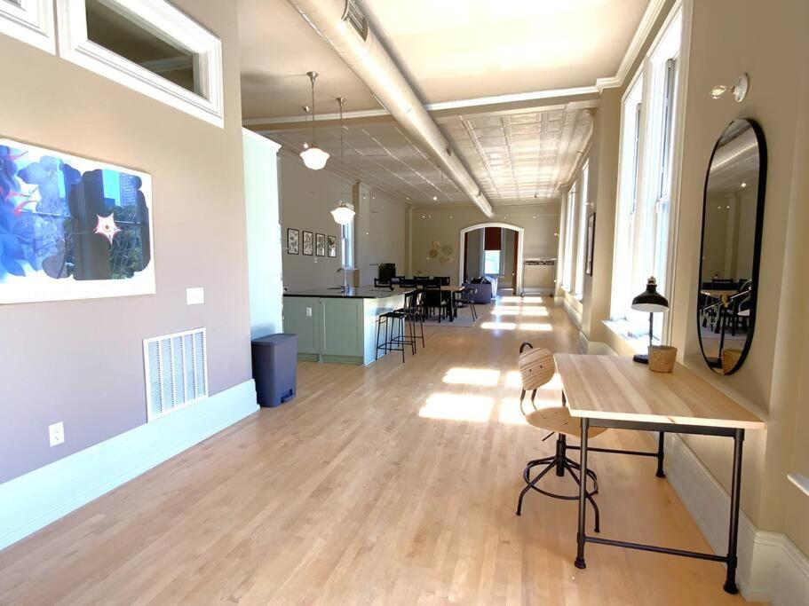 a living room with a table and a dining room at Modern Vintage Vibe Condo in Milwaukee