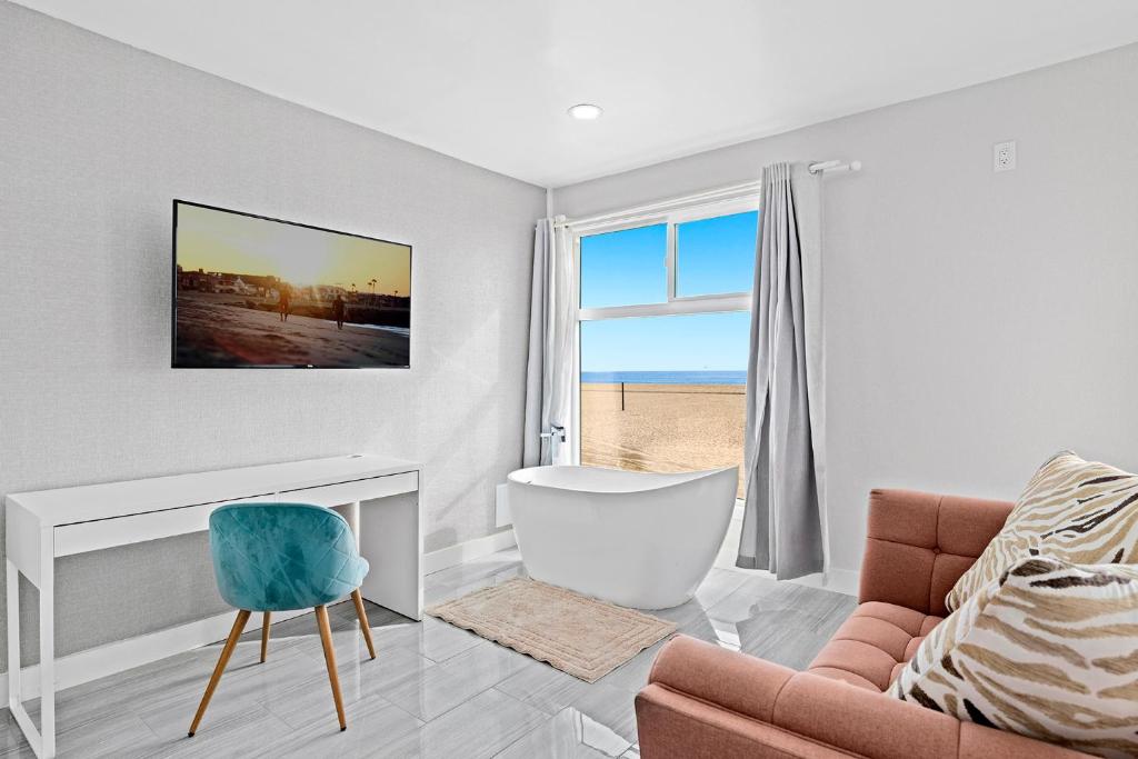 a living room with a couch and a chair at 1628 West Oceanfront Oasis 4,5,6,7,8,9 in Newport Beach