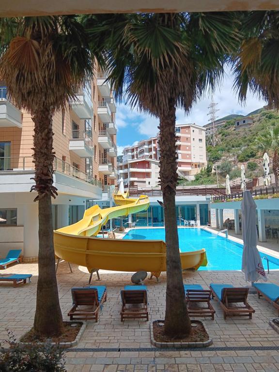 a yellow boat sitting next to a swimming pool at Diamond Hill Apartment in Vlorë