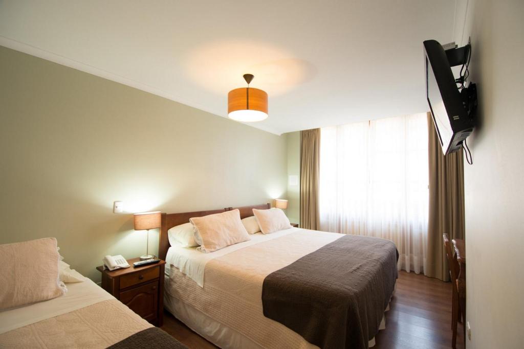 Postel nebo postele na pokoji v ubytování Hotel Loreto