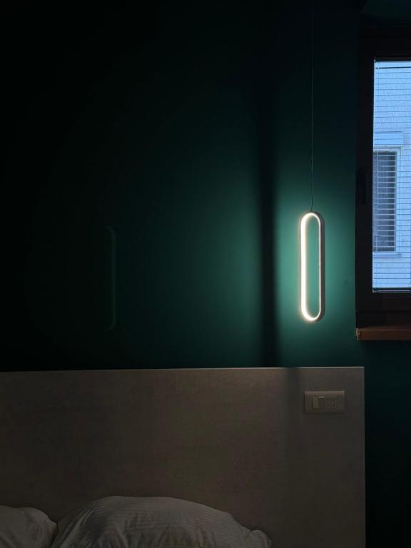 a green room with a bed and a window at Gigi Apartment by eluxory in Skopje