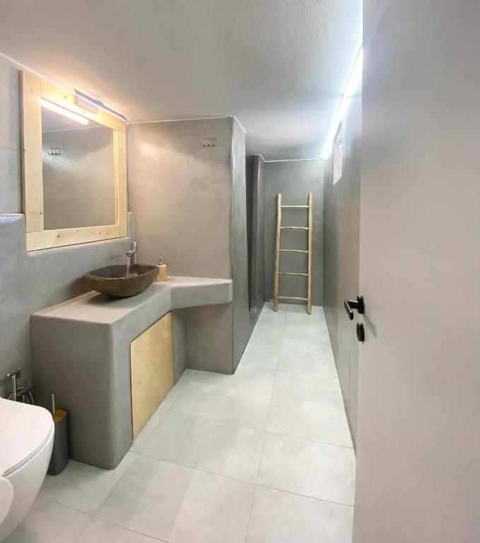 a bathroom with a sink and a toilet at Agia Kyriaki Studios in Agia Kiriaki Beach