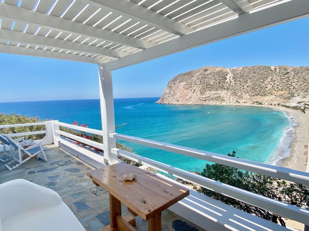 a balcony with a table and a view of the beach at Agia Kyriaki Studios in Agia Kiriaki Beach