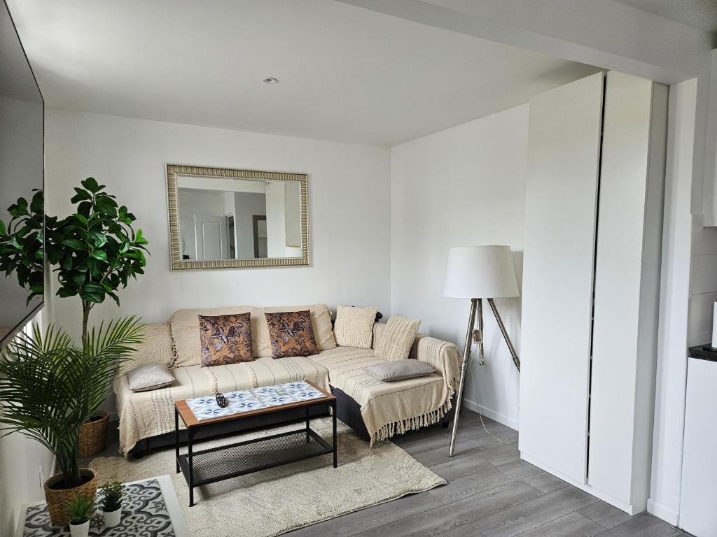 a living room with a couch and a table at spacieux duplex Stade de France 24 pour 4 personnes in Saint-Denis