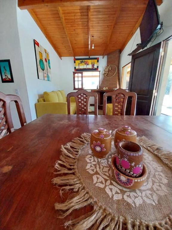 a wooden table with two cups on top of it at Barranca de la Luna in Tafí del Valle