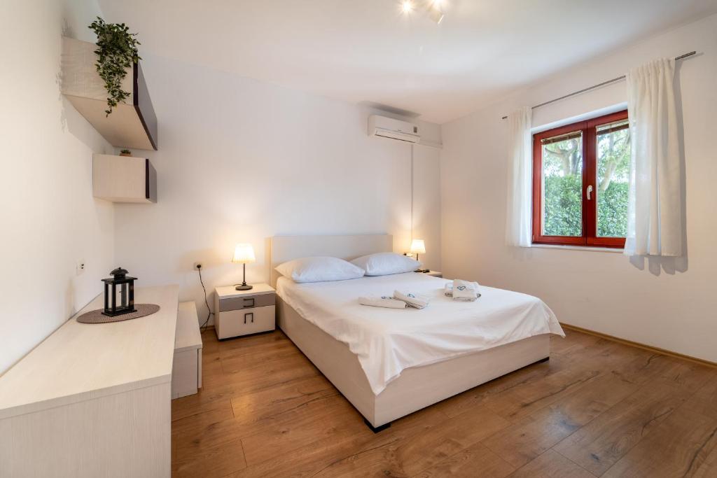 Posteľ alebo postele v izbe v ubytovaní Apartments Coronata
