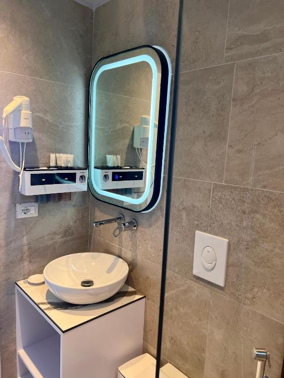 a bathroom with a sink and a mirror at Chalet Ambel in Dhërmi