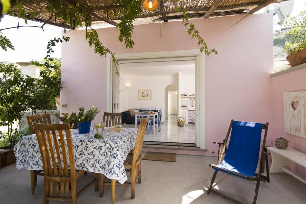a dining room with a table and chairs in a house at Casa Margherita Ischia in Ischia