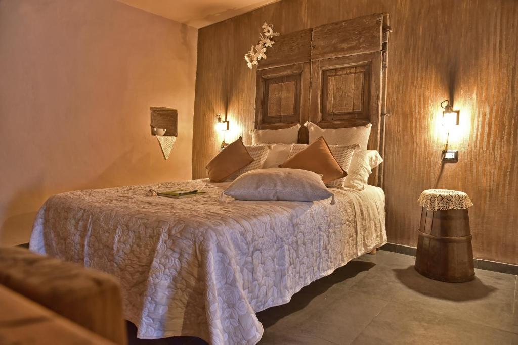 a bedroom with a bed with a wooden wall at Casa Vacanze Tra I Monti e San Martino in Biassa