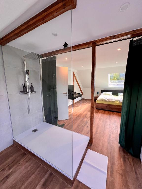 a glass shower in a room with a bedroom at Altes Eichamt Schweinfurt in Schweinfurt