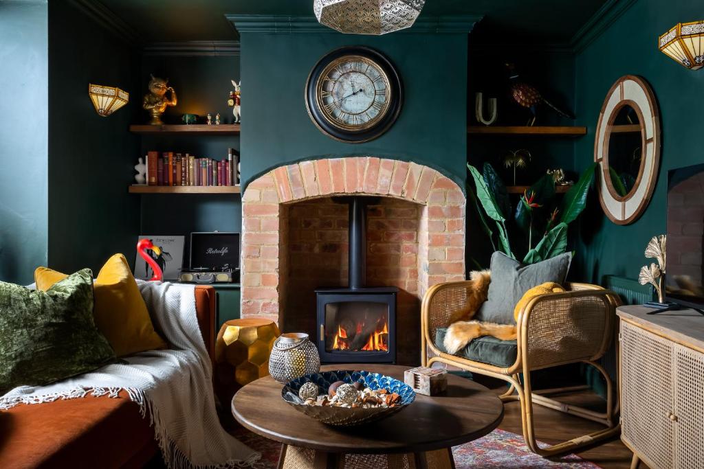 a living room with a fireplace and a couch at Chipping Campden Shabby Chic on Famous High Street in Gloucestershire