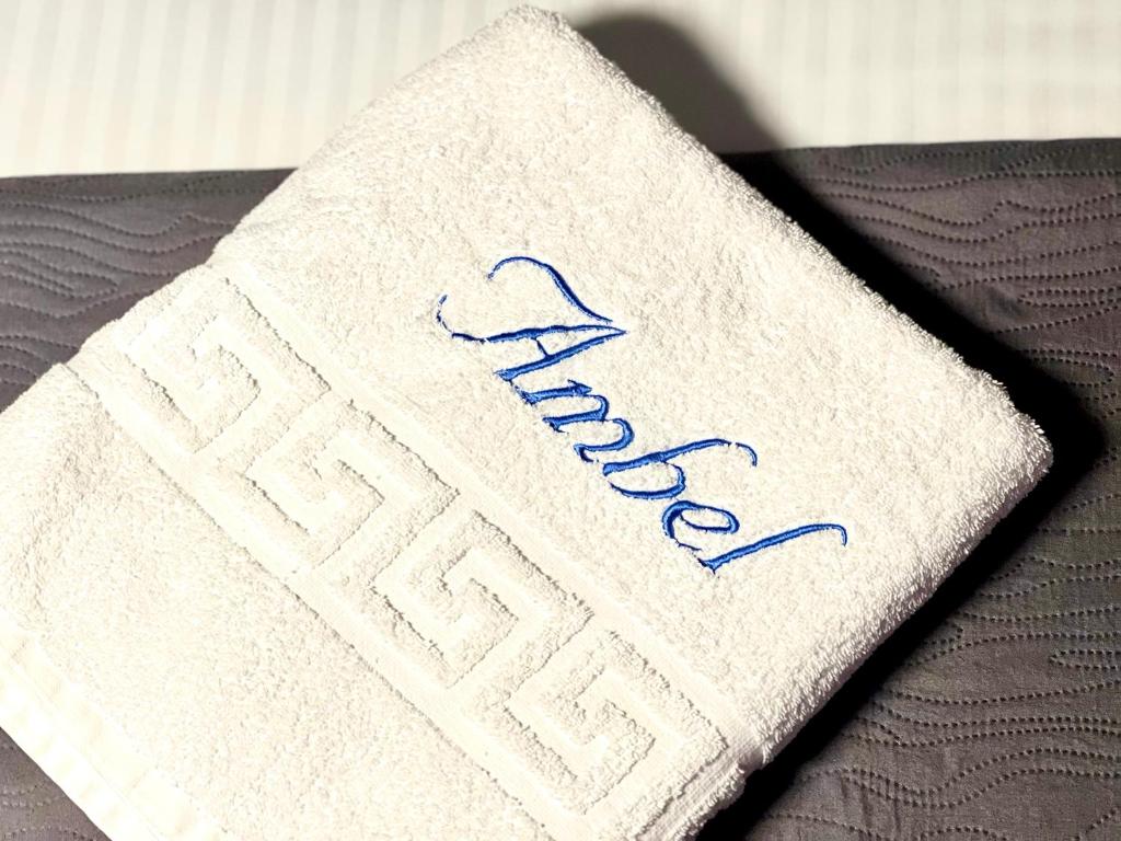 a white napkin with the wordarma written on it at Chalet Ambel in Dhërmi